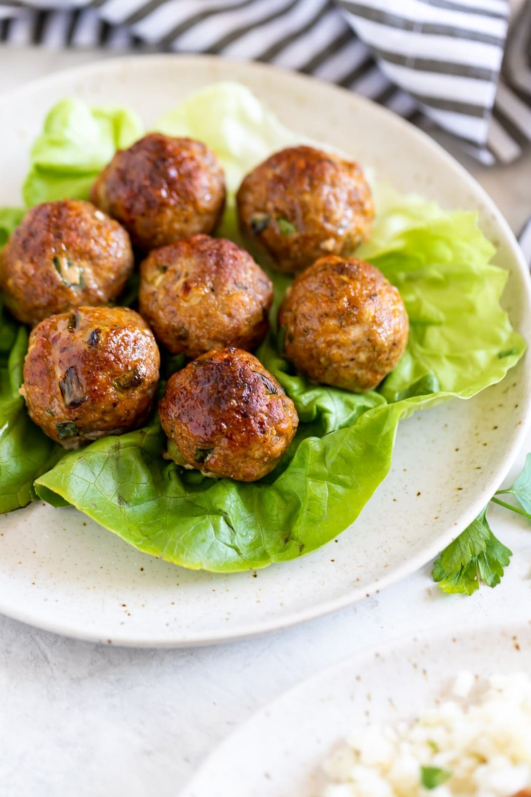 Turkey meatballs displayed on bed of lettuce