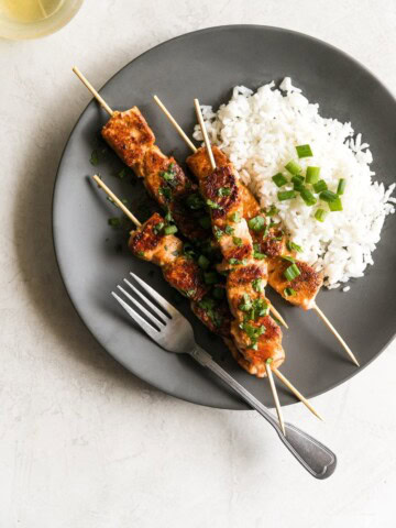 Salmon marinated in honey, garlic, soy sauce, fresh lime juice then cooked on skewers for 10 minutes in a cast iron skillet. A simple yet gourmet weeknight meal!
