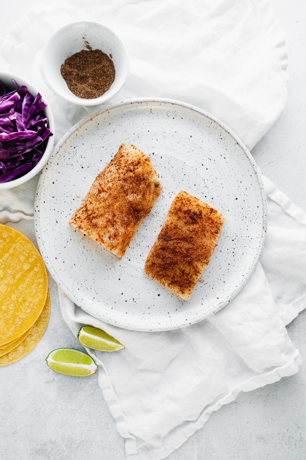 white fish seasoned with smoky spices before cooking