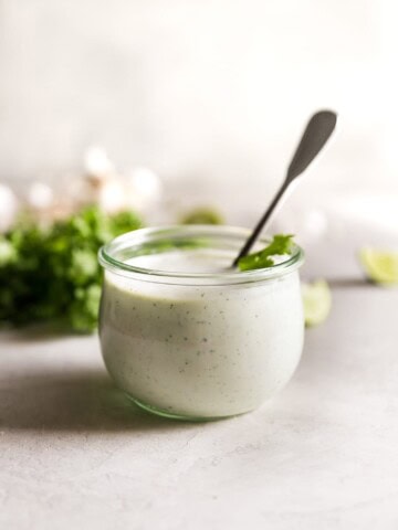 cilantro garlic sauce in jar with spoon inside the jar