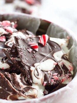 Sleigh the holidays with Boozy Marshmallow Peppermint Bark! Melted marshmallow mixed with peppermint schnapps, swirled on melted dark chocolate then topped with crushed candy canes.
