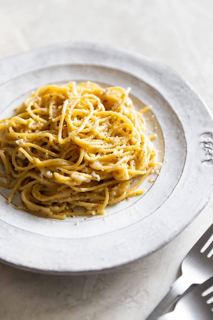 bowl of cacio e pepe pasta on a white plate