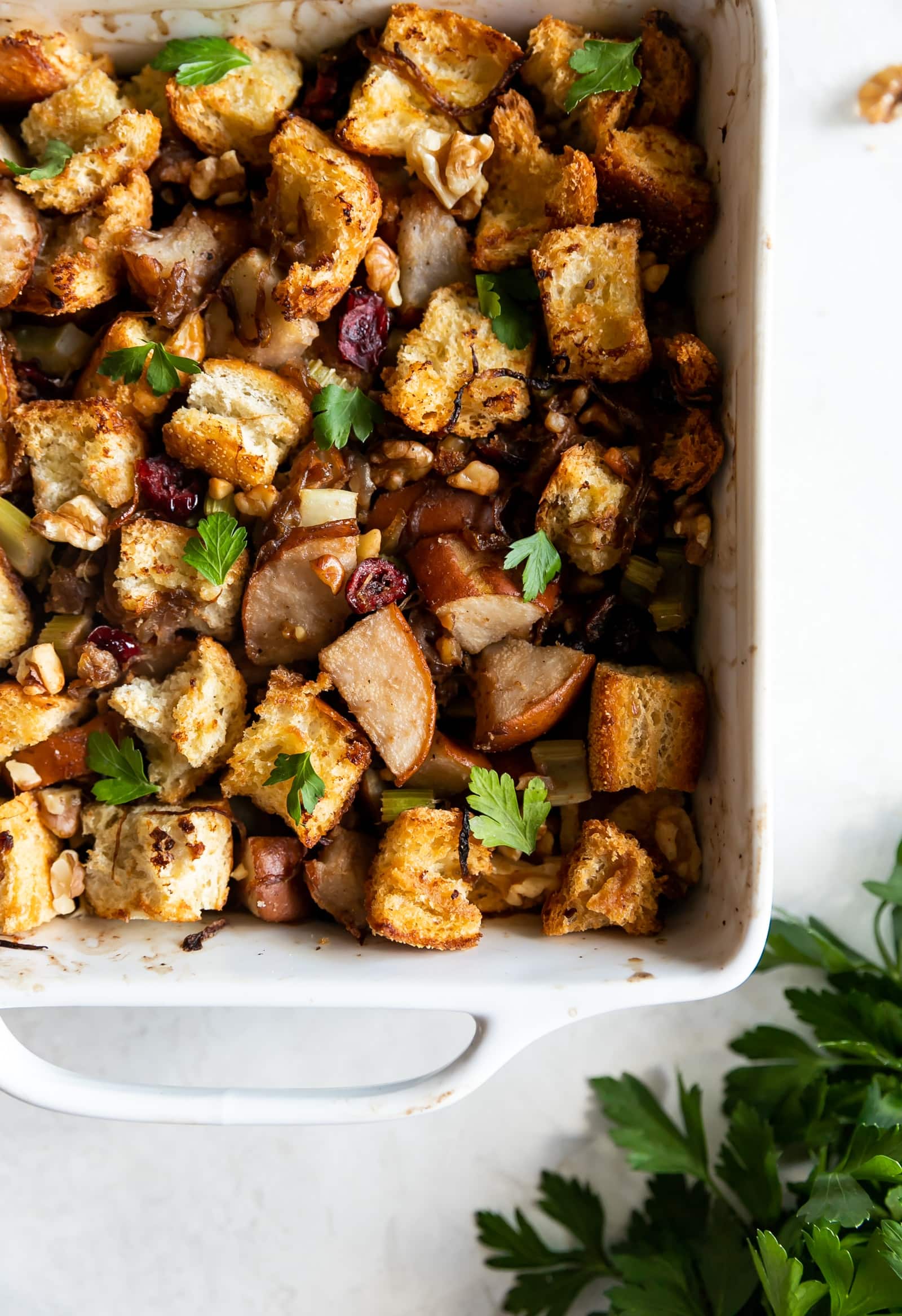 Caramelized Onion Pear & Walnut Stuffing. A flavorful and easy-to-make Thanksgiving stuffing made with caramelized onions, pears, celery, walnuts, and dried cranberries. #stuffing #thanksgiving