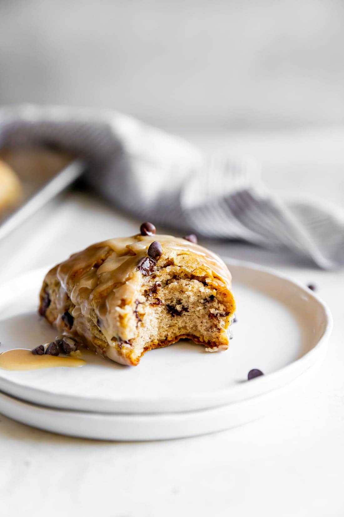 chai chocolate chip scone with espresso glaze with a bite taken out of it