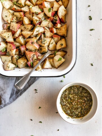 The easiest side dish ever. Roasted potatoes tossed in a delicious, super easy to make cilantro garlic chimichurri sauce!