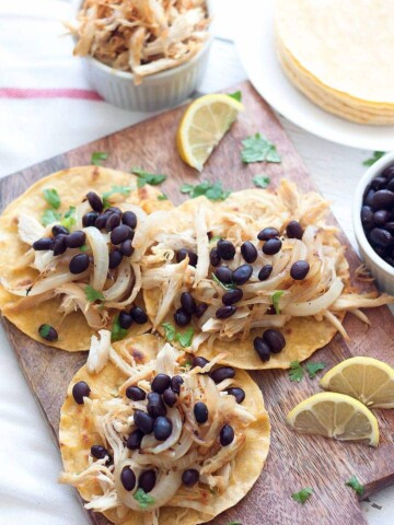 Using leftovers or shredded rotisserie chicken, make these Crispy Chicken Tacos, vaca frita style, topped with sautéed onions and black beans!