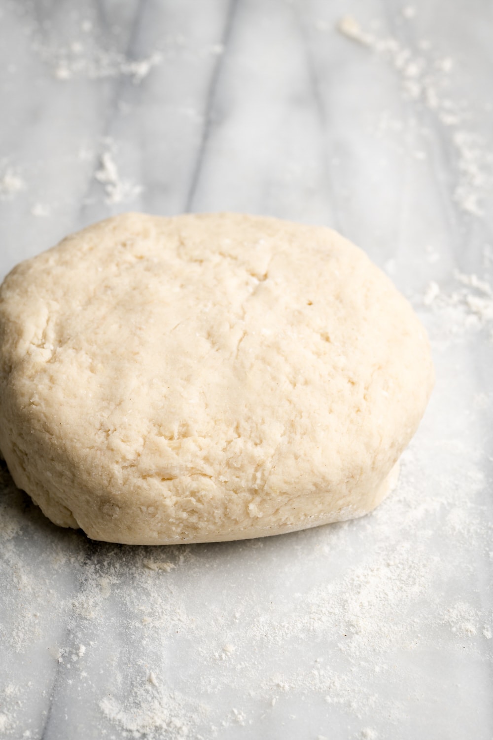 dough formed with root vegetables on a marble surface