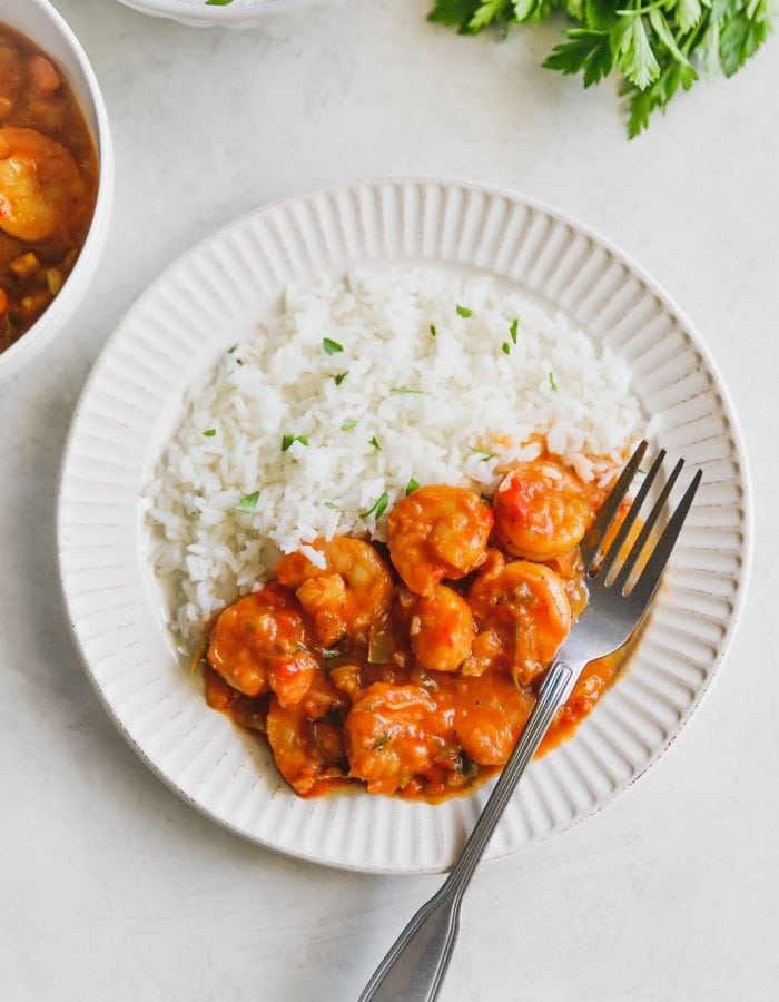 deviled shrimp on a white plate with white rice