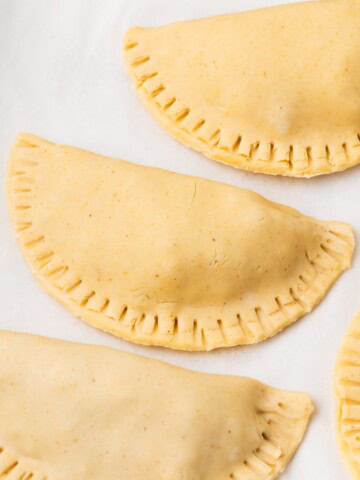 empanadas on a baking sheet before frying