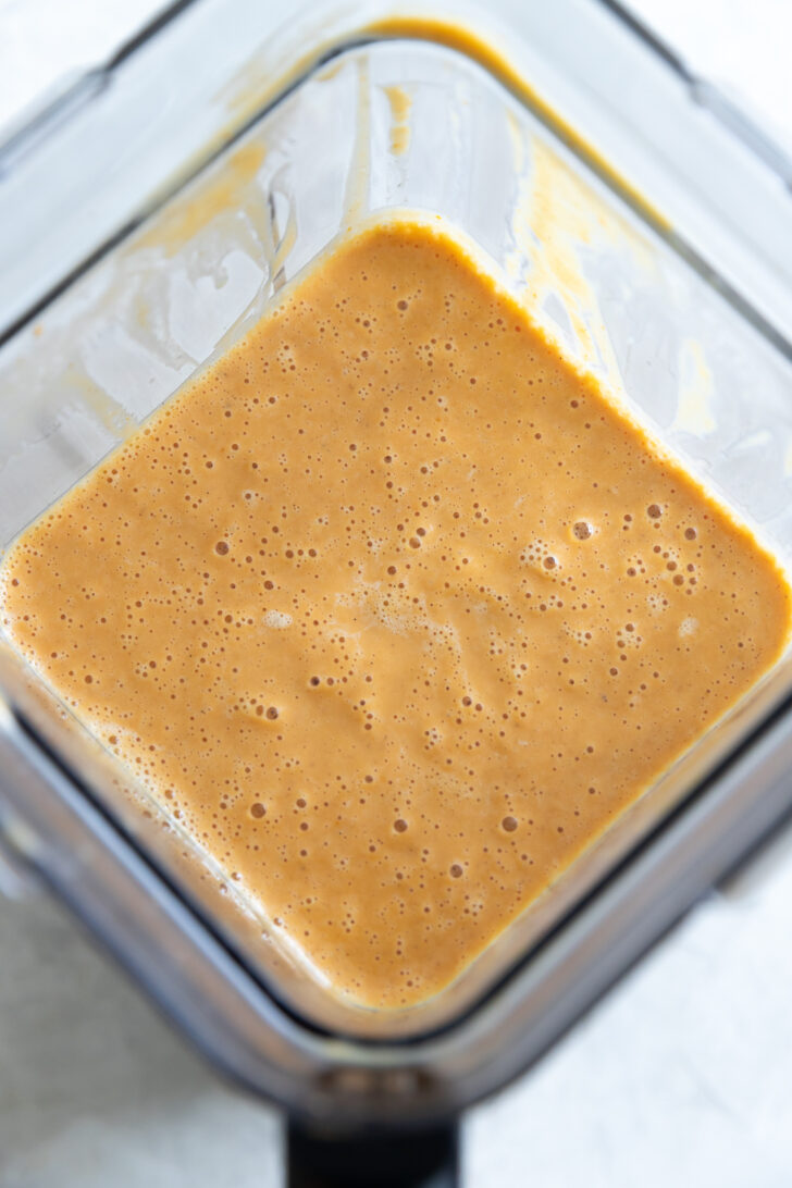 Creamy caramel sauce in a glass blender for dessert recipes.