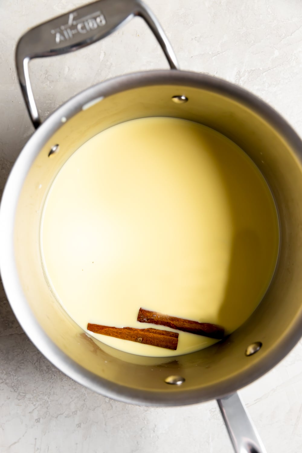 fresh corn kernels blended with milk in a saucepan with cinnamon sticks before cooking