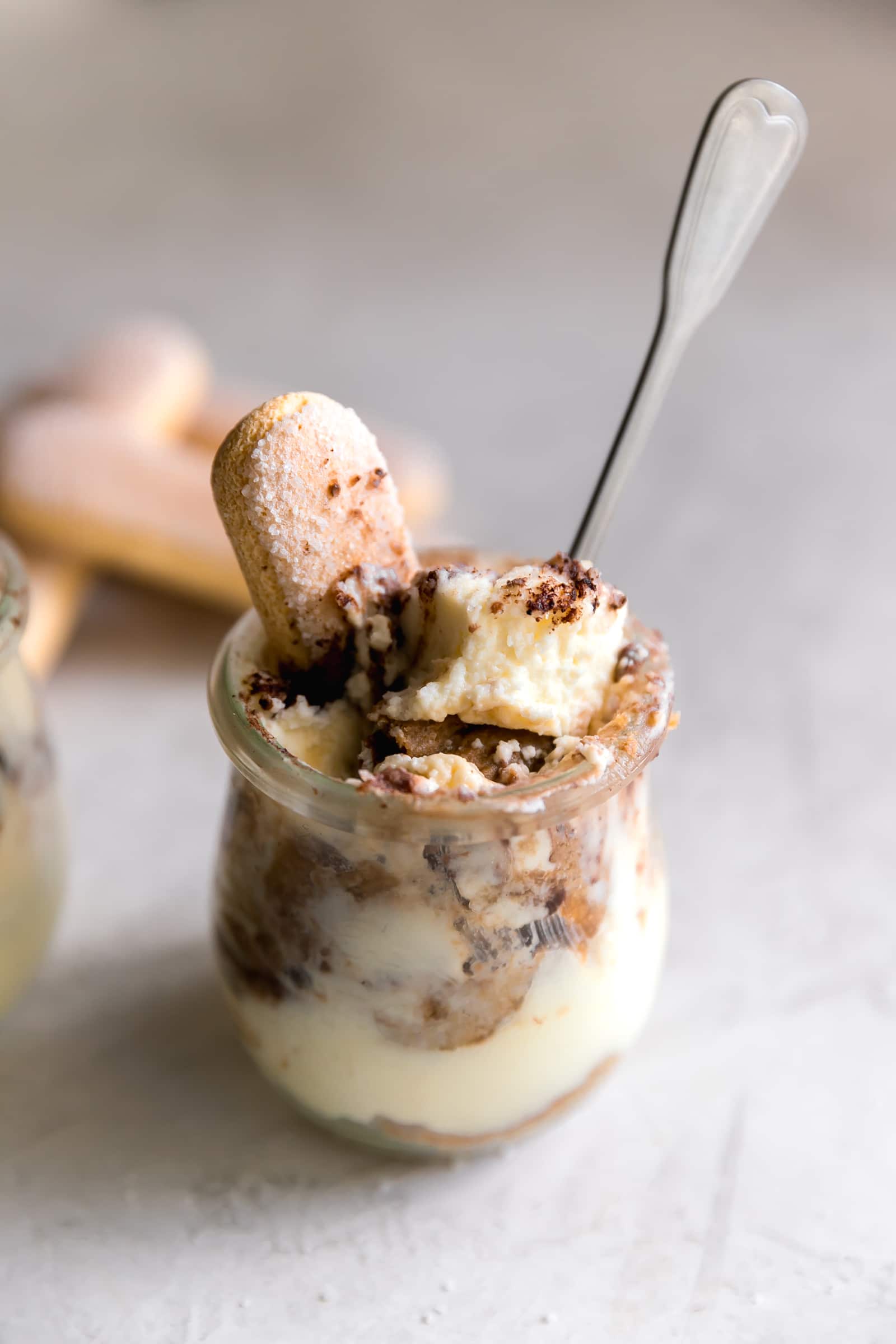 Tiramisu cup with mascarpone mousse, espresso soaked ladyfingers and cocoa powder