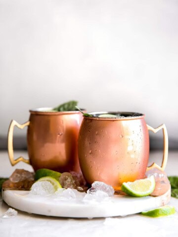 Guava Basil Moscow Mule. A twist to the traditional refreshing Vodka cocktail made with spicy ginger beer, guava nectar, fresh lime and sweet basil. Delicious drink for any time of year!
