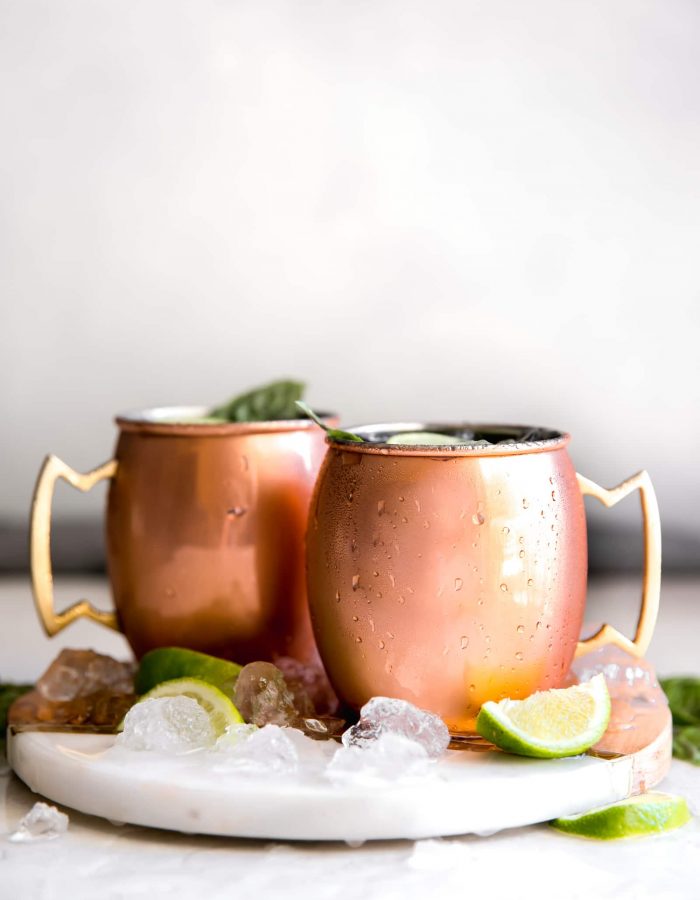 Guava Basil Moscow Mule. A twist to the traditional refreshing Vodka cocktail made with spicy ginger beer, guava nectar, fresh lime and sweet basil. Delicious drink for any time of year!