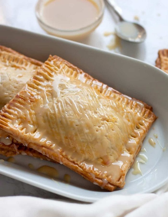 Super easy, semi-homemade guava and cream cheese pop tarts made using refrigerated pie crust then topped with a drizzle of condensed milk. The perfect combination of a Cuban treat on an American classic.