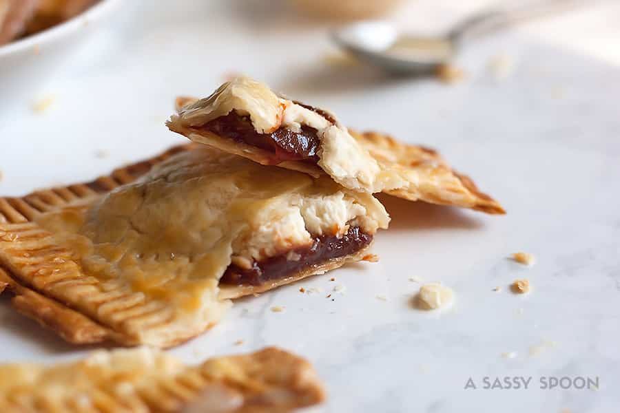 Super easy, semi-homemade guava and cream cheese pop tarts made using refrigerated pie crust then topped with a drizzle of condensed milk. The perfect combination of a Cuban treat on an American classic.