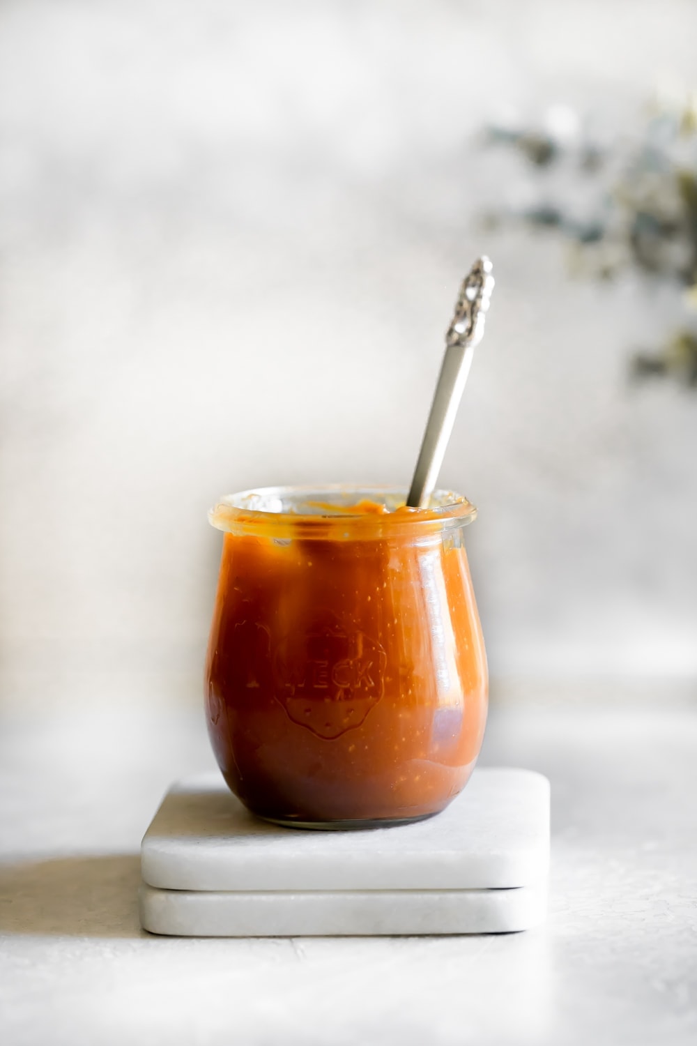 a jar of salted caramel sauce with a spoon