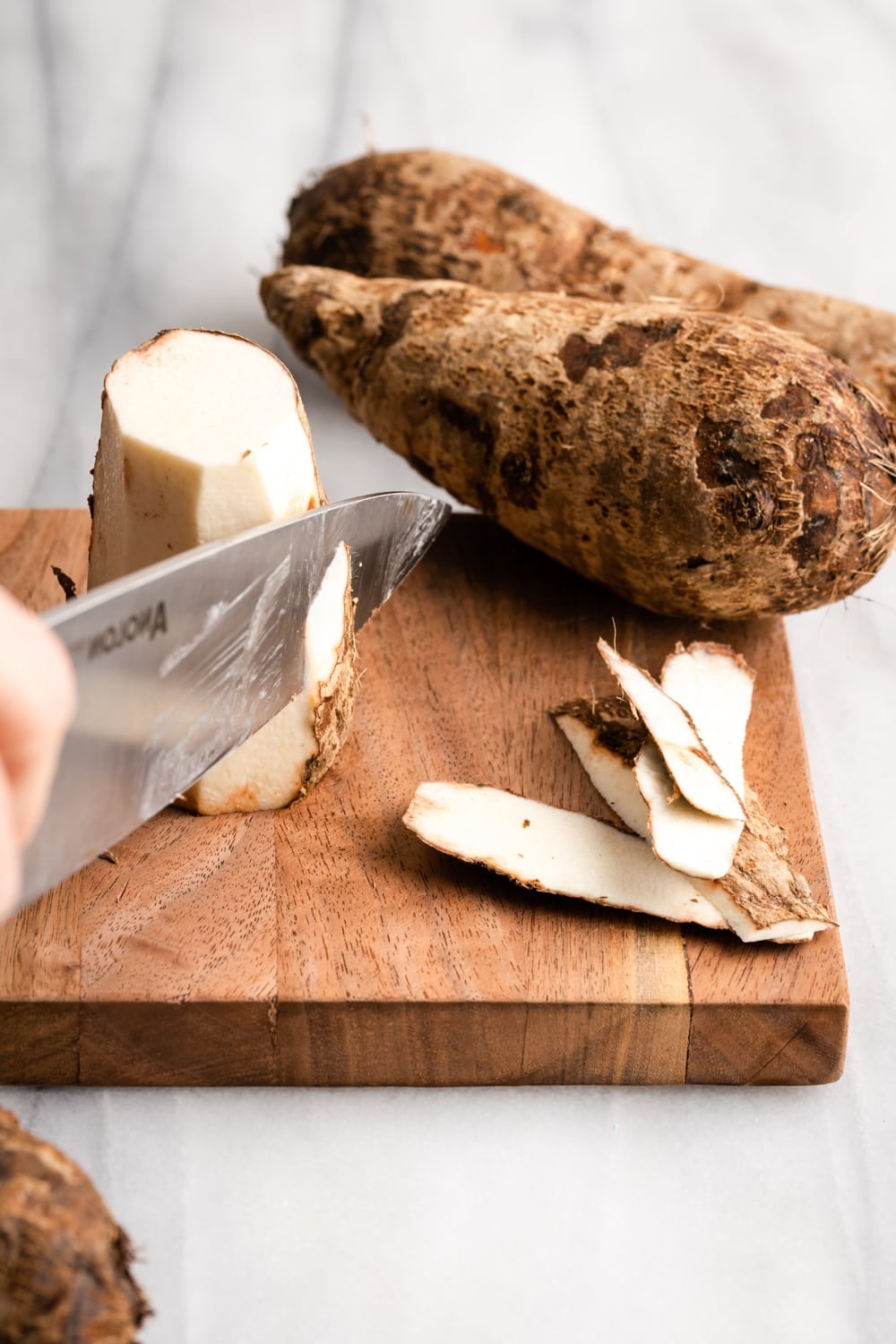 malanga being peeled with a knife