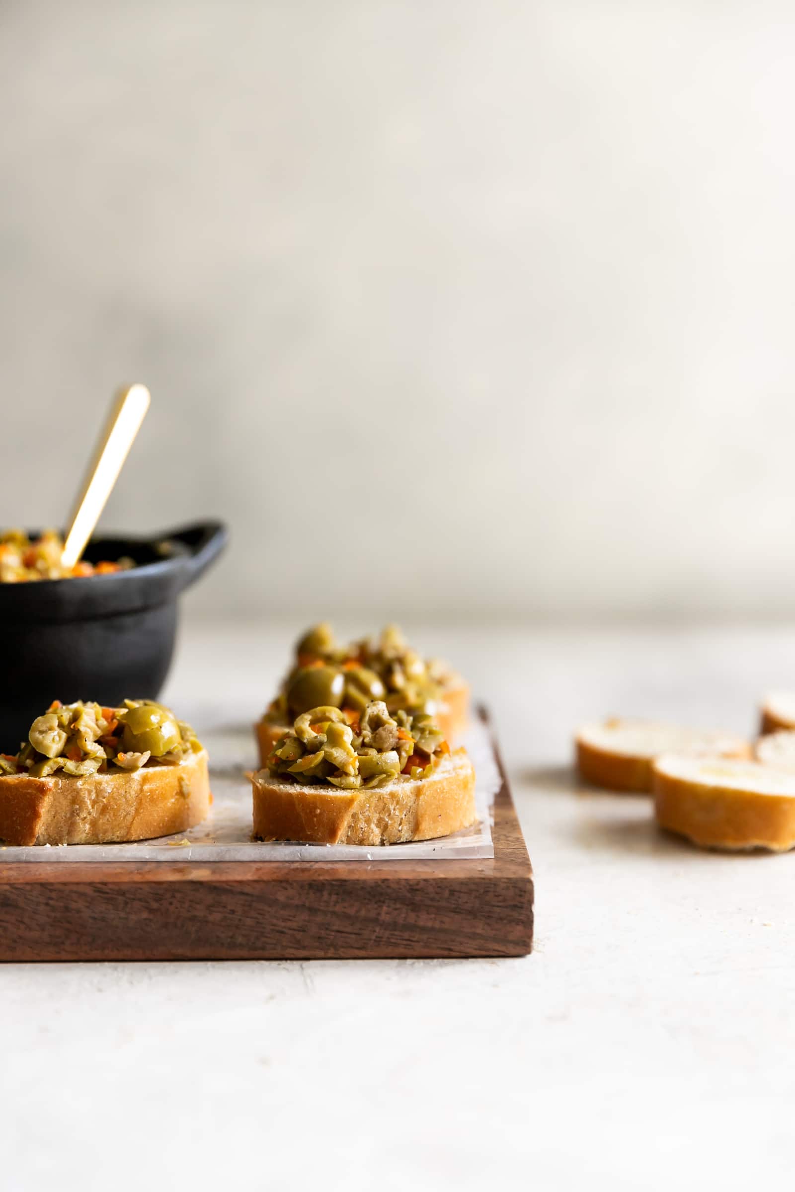A simple yet irresistible appetizer made with tart, briny olives, capers, fresh garlic, pepper, and olive oil then served on toasted baguette slices brushed with olive oil.