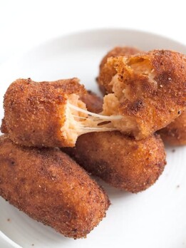 Turn pizza into a croqueta! These bite-sized Pizza Croquettes are crispy logs filled with mozzarella, tomato, and spices. Small bites with BIG pizza flavors.