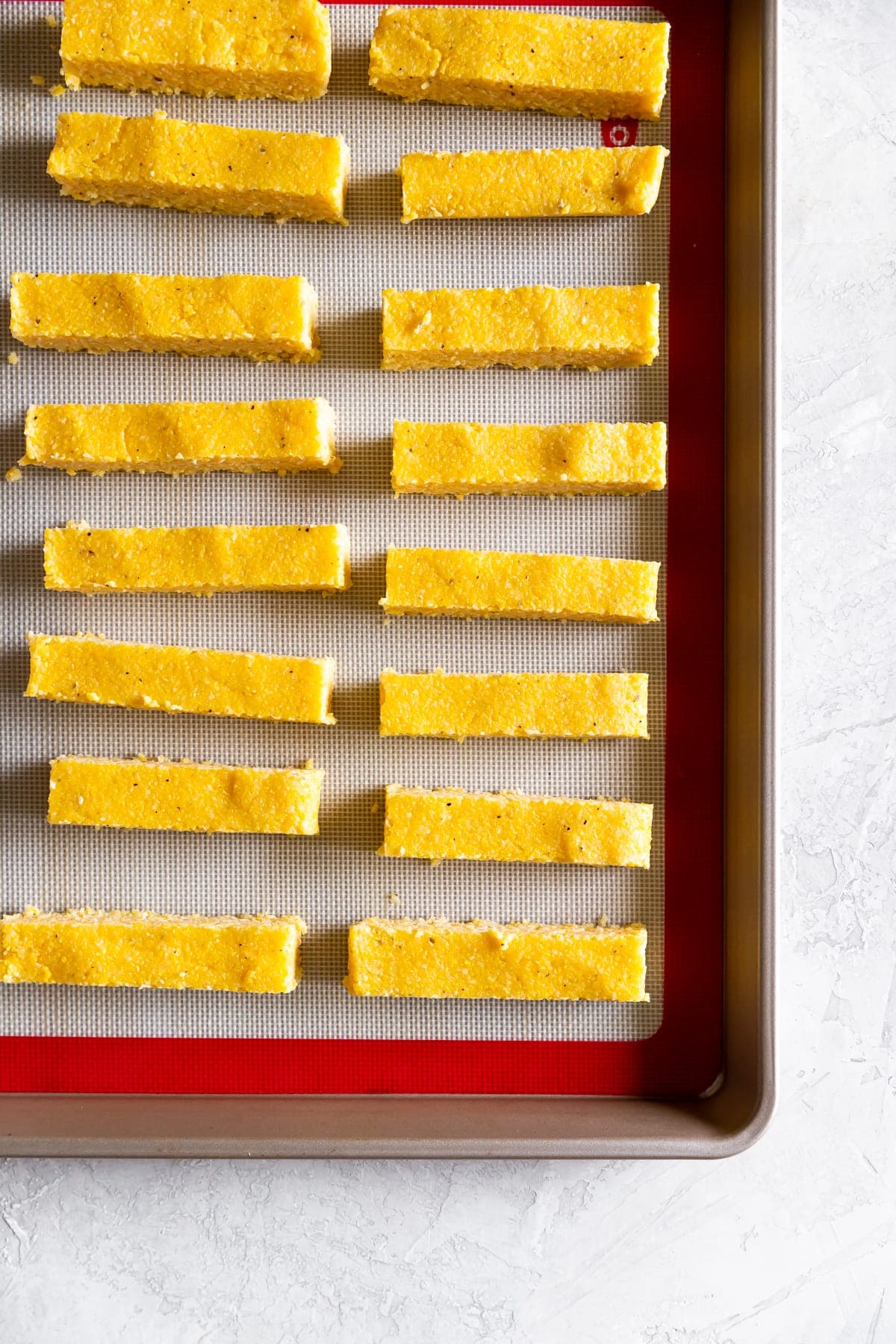 cut up polenta on a baking sheet