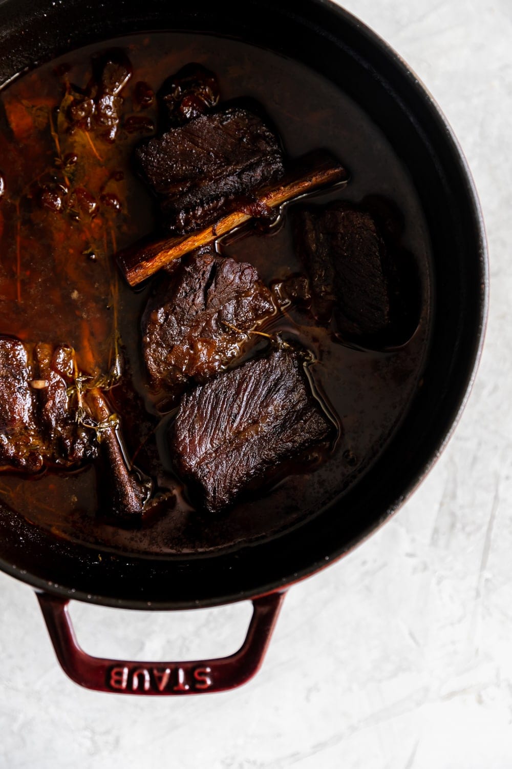 cooked red wine braised short ribs in a Staub Dutch oven