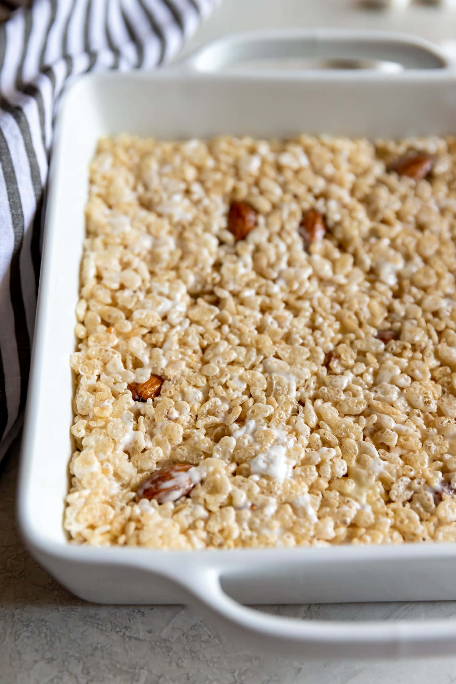 A sweet crispy classic treat with a smoky twist! Rice cereal, torched marshmallows, and smoked almonds come together to make Smoky Rice Krispie Treats.
