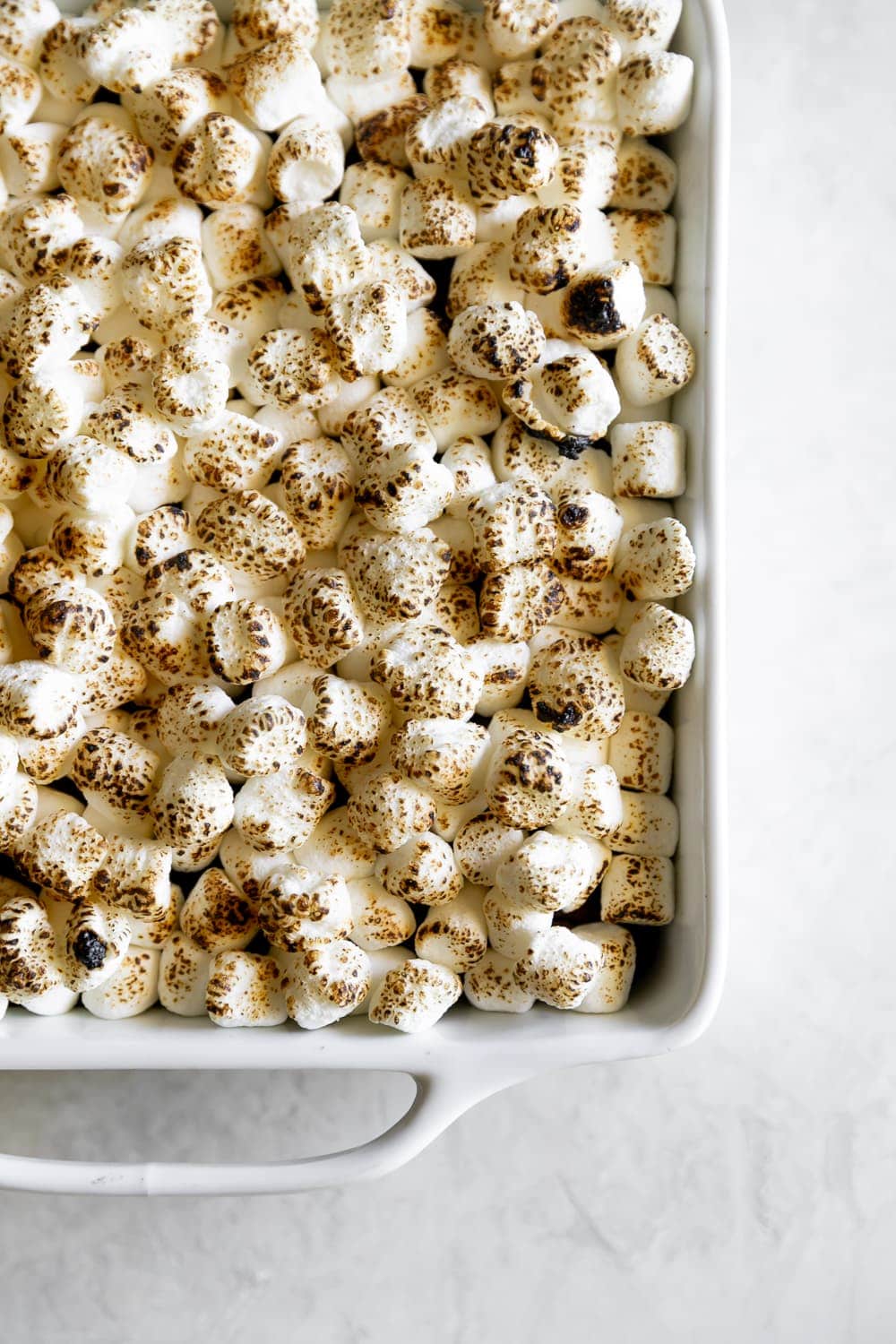 top view of toasted marshmallows in white baking dish