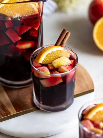 A deliciously fall-flavored red wine sangria made with pears, apples, sliced oranges and warm spices like cinnamon, ginger, and cardamom. #sangria