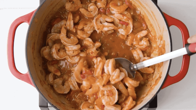 Cooked camarones enchilados with the tomato-based sauce with sofrito in a Dutch oven